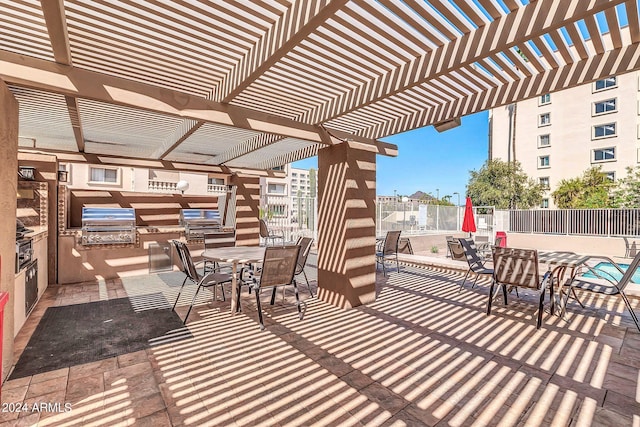 view of patio featuring area for grilling and a pergola