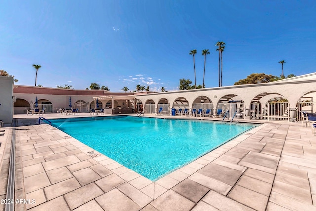 view of swimming pool featuring a patio area