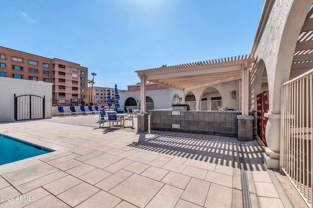 view of patio with a pergola and a community pool