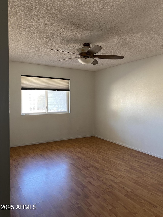 spare room featuring hardwood / wood-style flooring, a textured ceiling, and ceiling fan