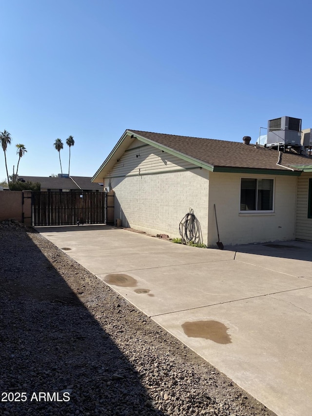 exterior space with central AC unit and a patio area