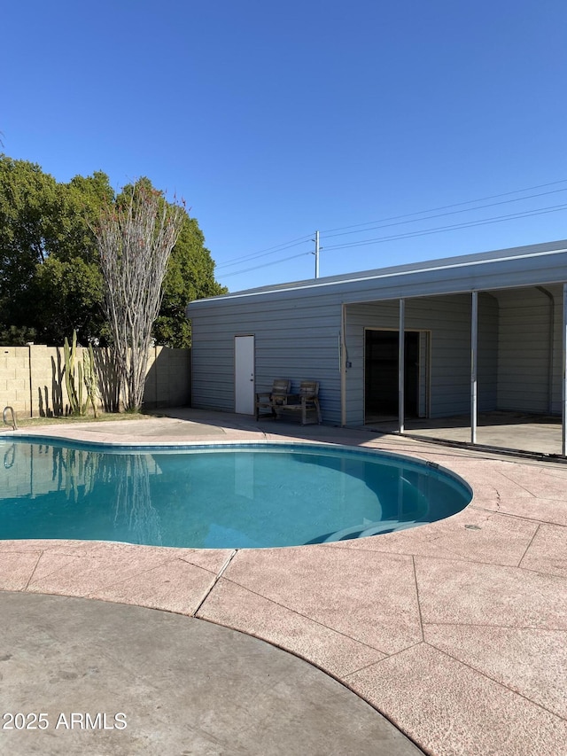 view of swimming pool with a patio