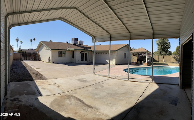 view of pool with cooling unit and a gazebo