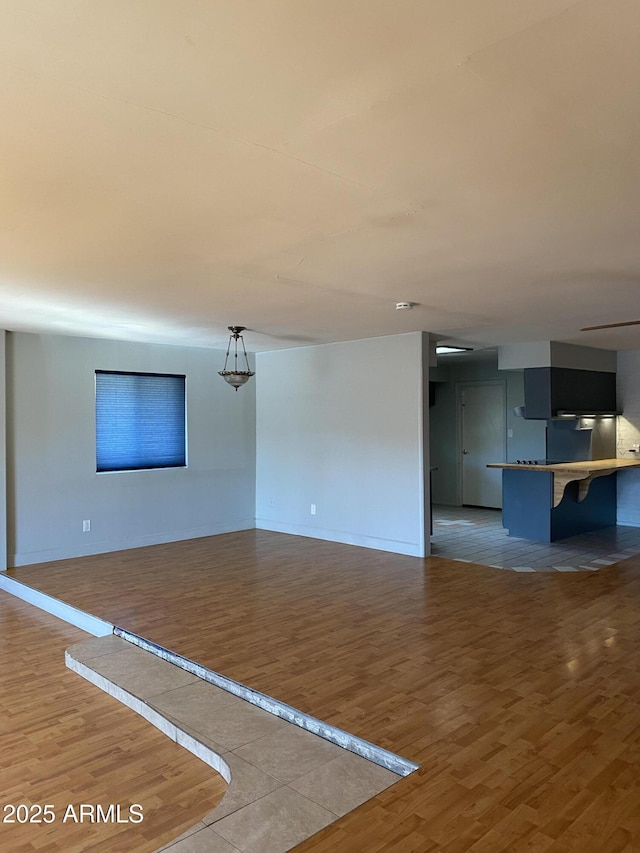 unfurnished living room with hardwood / wood-style flooring