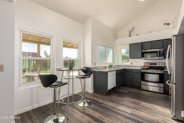 kitchen with dark hardwood / wood-style flooring, appliances with stainless steel finishes, light stone counters, gray cabinets, and sink