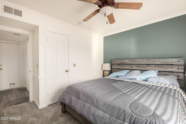 bedroom with ceiling fan, ornamental molding, and dark hardwood / wood-style flooring