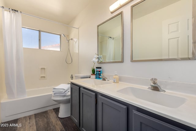 full bathroom featuring toilet, dual sinks, shower / tub combo with curtain, large vanity, and hardwood / wood-style flooring