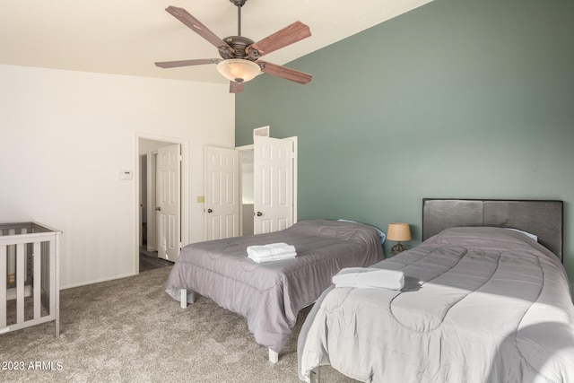 bedroom featuring dark colored carpet, ceiling fan, and high vaulted ceiling