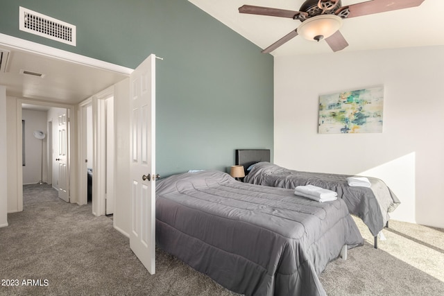 bedroom with lofted ceiling, dark carpet, and ceiling fan