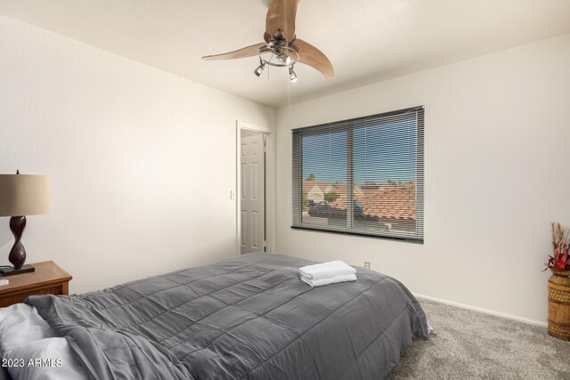 carpeted bedroom with ceiling fan