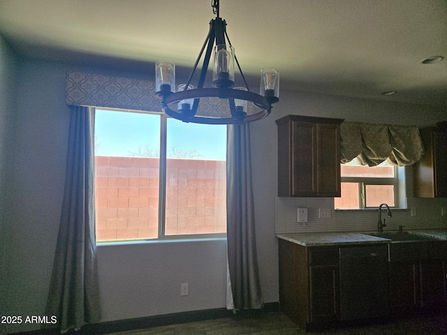 9302 W Georgia Ave, Glendale, AZ 85305 - kitchen featuring a chandelier, a sink, healthy amount of natural light, and backsplash