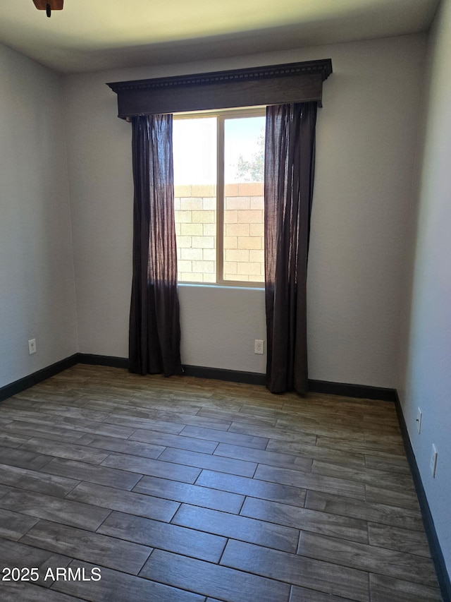 9302 W Georgia Ave, Glendale, AZ 85305 - spare room with dark wood-style flooring and baseboards