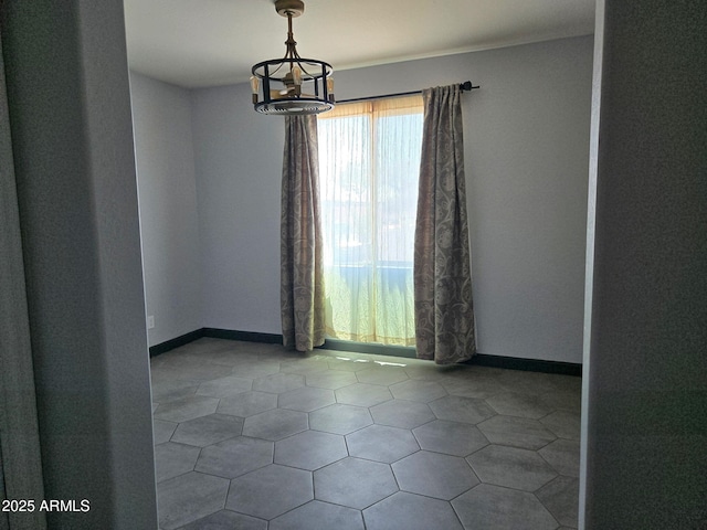 9302 W Georgia Ave, Glendale, AZ 85305 - empty room featuring a chandelier and baseboards