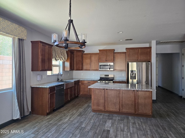 9302 W Georgia Ave, Glendale, AZ 85305 - kitchen with stainless steel appliances, dark wood-style flooring, a center island, and a sink