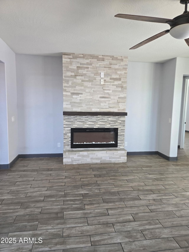 9302 W Georgia Ave, Glendale, AZ 85305 - unfurnished living room featuring a ceiling fan, a fireplace, wood finished floors, a textured ceiling, and baseboards