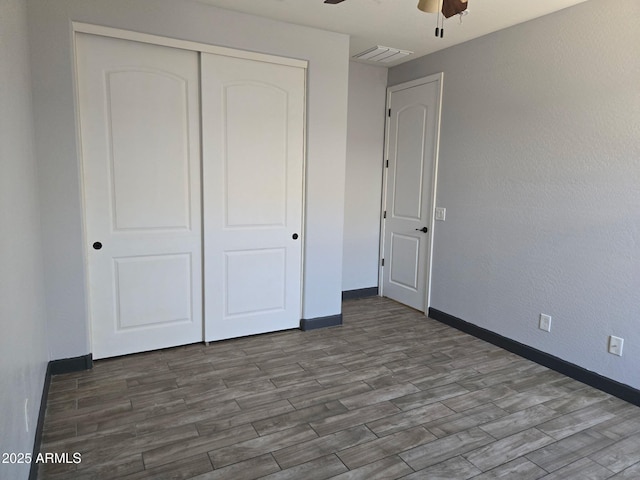 9302 W Georgia Ave, Glendale, AZ 85305 - unfurnished bedroom featuring wood finished floors, a closet, baseboards, and a ceiling fan