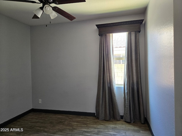 9302 W Georgia Ave, Glendale, AZ 85305 - empty room with dark wood-style flooring, ceiling fan, and baseboards