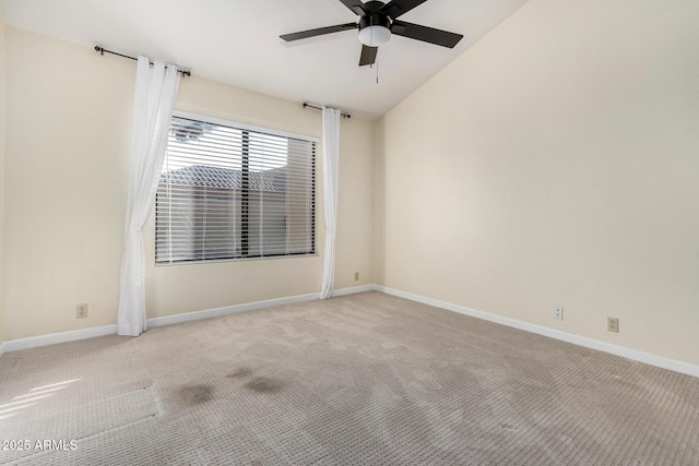 carpeted empty room featuring lofted ceiling and ceiling fan