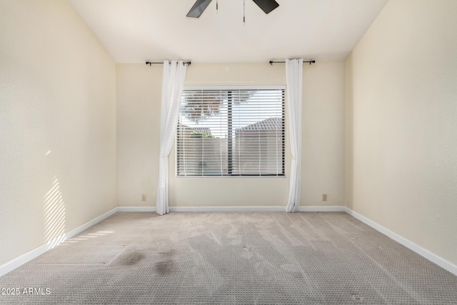 carpeted empty room featuring ceiling fan