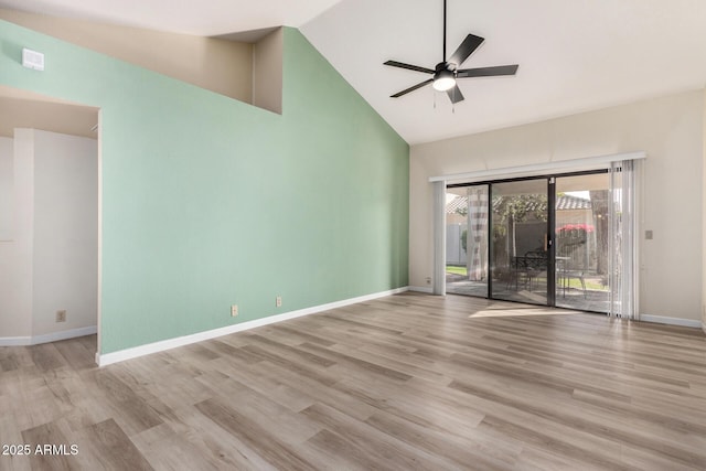 empty room featuring high vaulted ceiling, light hardwood / wood-style floors, and ceiling fan