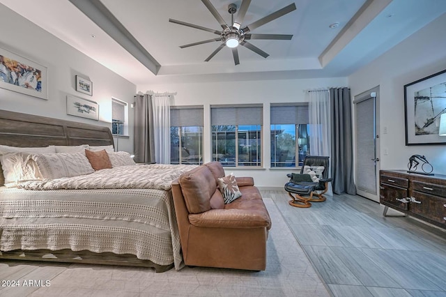 bedroom featuring ceiling fan and a tray ceiling