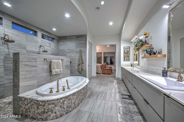 bathroom with vanity and shower with separate bathtub