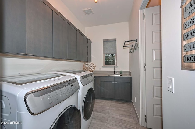 laundry room with cabinets, sink, and washing machine and clothes dryer