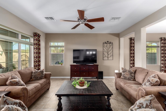 living room featuring plenty of natural light, baseboards, and visible vents