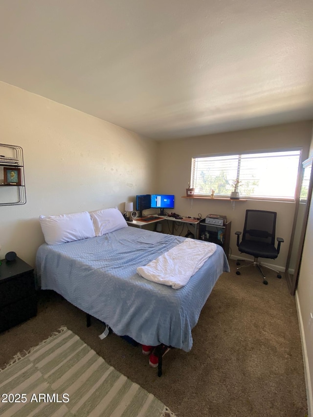 carpeted bedroom with baseboards