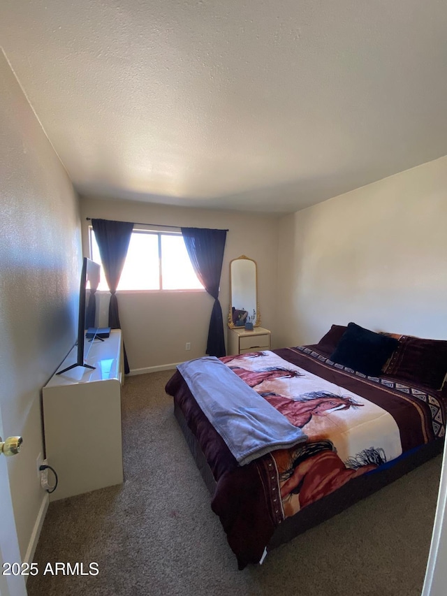 bedroom with a textured ceiling, carpet flooring, and baseboards