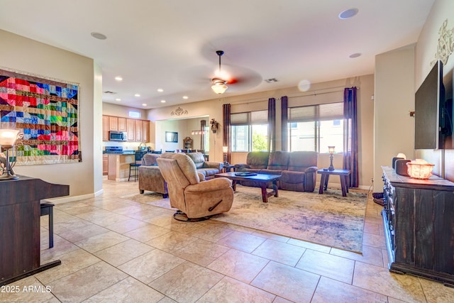 living room with a ceiling fan, visible vents, baseboards, light tile patterned flooring, and recessed lighting