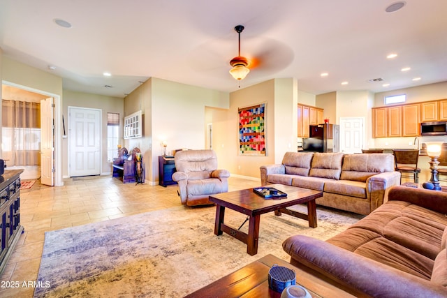 living area with a ceiling fan, visible vents, recessed lighting, and baseboards