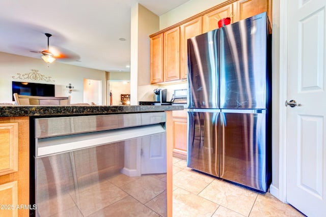 kitchen with light tile patterned floors, ceiling fan, light brown cabinets, and freestanding refrigerator