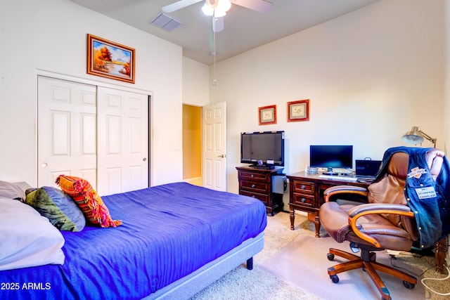 carpeted bedroom with a closet, visible vents, and a ceiling fan