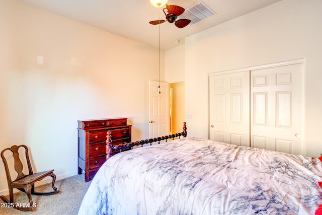 bedroom featuring visible vents, baseboards, ceiling fan, carpet floors, and a closet