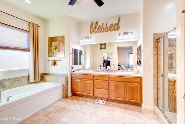 bathroom featuring a garden tub, double vanity, a stall shower, and a sink