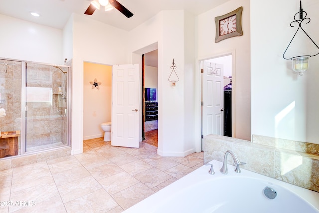 bathroom featuring a bath, baseboards, ceiling fan, a shower stall, and toilet