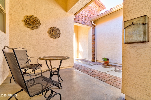 exterior space with stucco siding and a patio