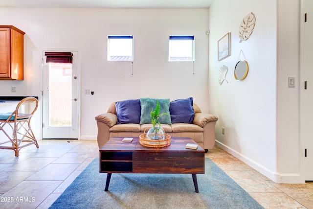 living room with light tile patterned floors and baseboards