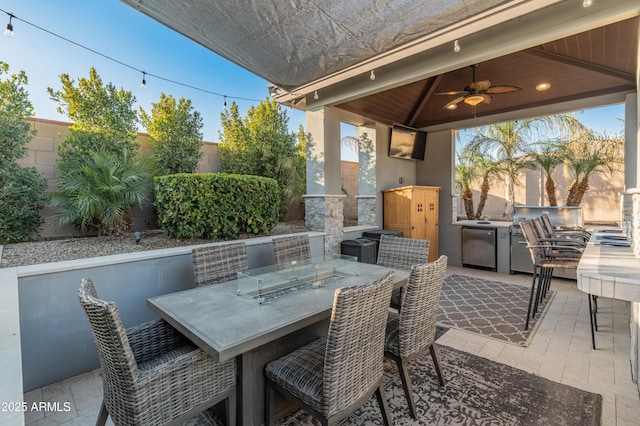 view of patio / terrace with a gazebo, ceiling fan, and exterior kitchen