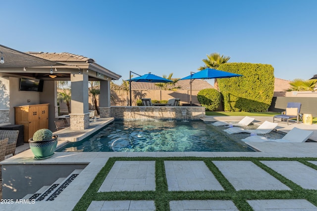 view of swimming pool featuring pool water feature, ceiling fan, and a patio area