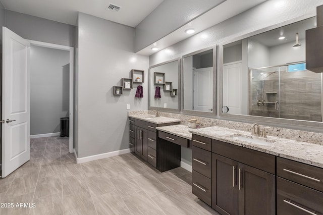 bathroom with vanity and a shower with shower door