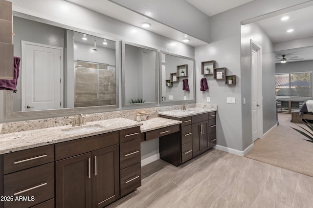 bathroom featuring vanity, ceiling fan, and walk in shower