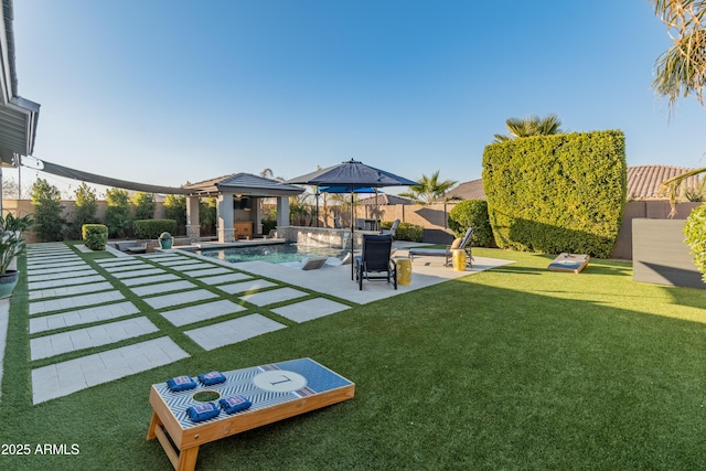 view of yard with a fenced in pool, a patio, and a gazebo