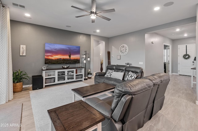 living room with ceiling fan and light hardwood / wood-style flooring