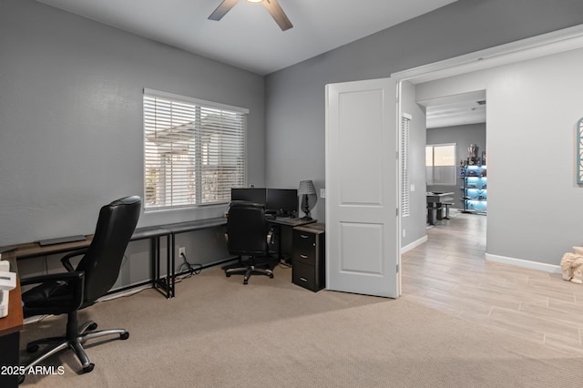 carpeted home office featuring ceiling fan and lofted ceiling