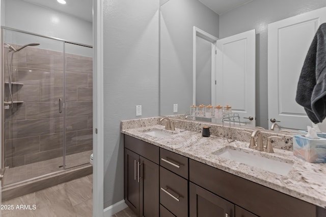 bathroom with walk in shower, vanity, and toilet