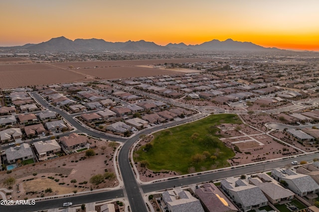 aerial view at dusk featuring a mountain view