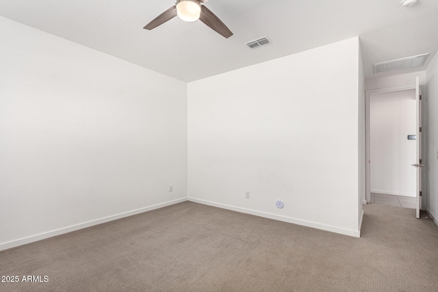 empty room featuring carpet, visible vents, ceiling fan, and baseboards