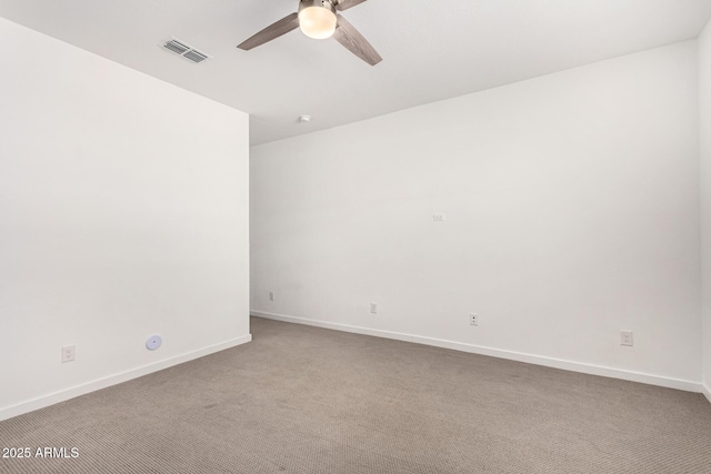 empty room featuring visible vents, carpet, a ceiling fan, and baseboards